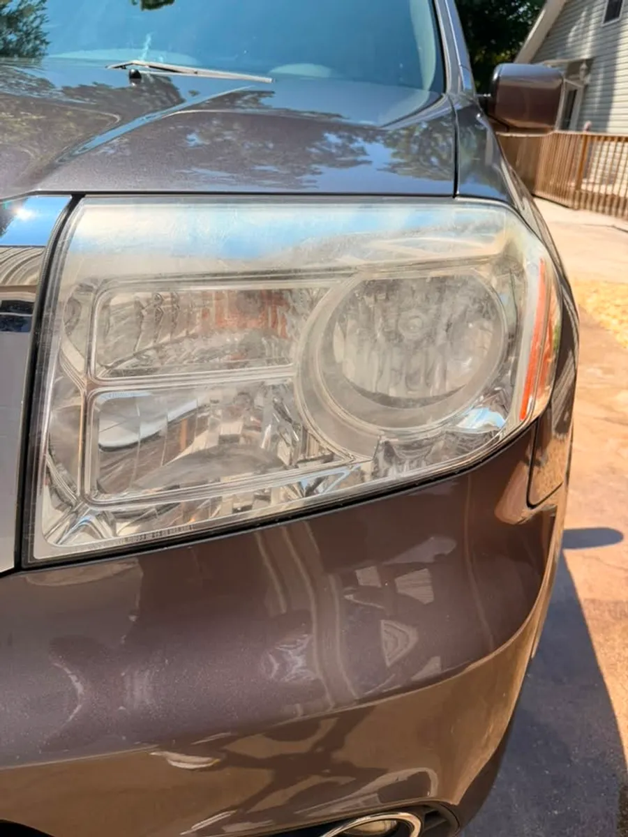 Before: Headlight restoration on a Honda Pilot in Chattanooga, TN - driver side